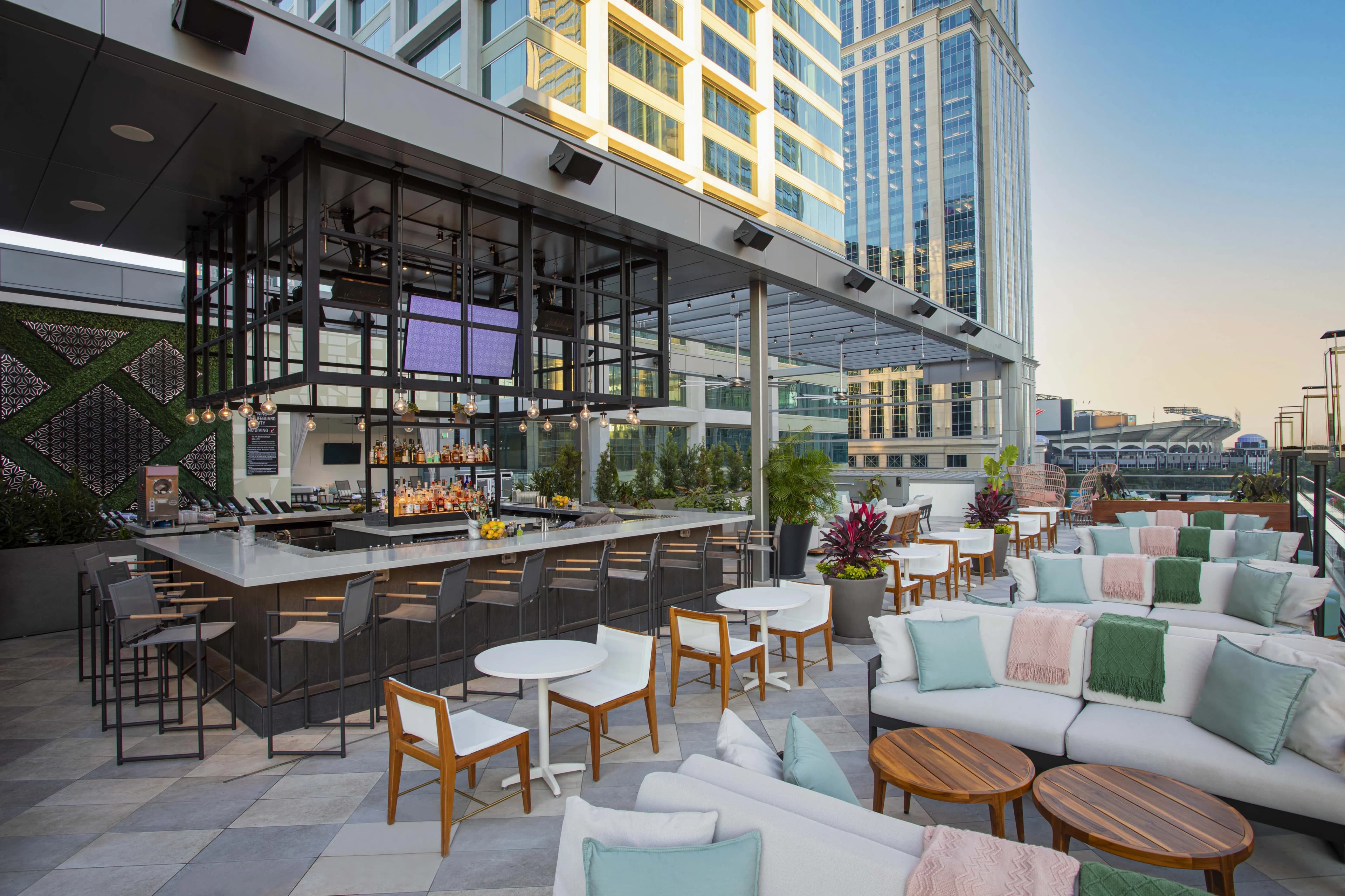 Rooftop bar with couches and tables and the bar itself in the middle