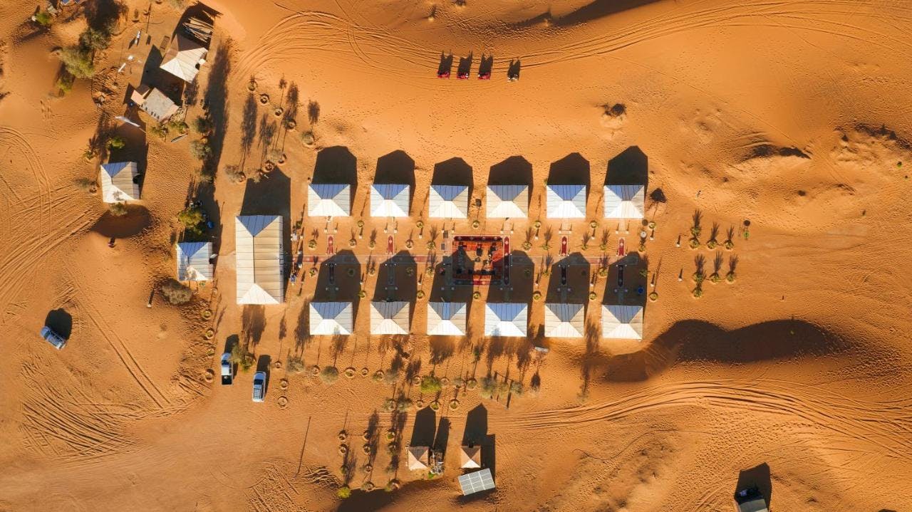 drone picture of the tents at dunes luxury camp