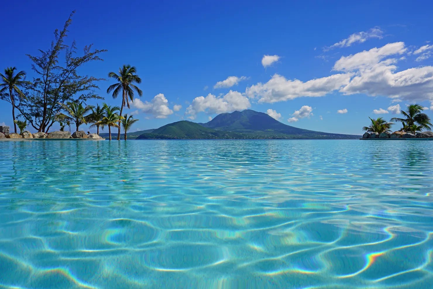 View of the Nevis Peak volcano from a swimming pool in Christopher Harbour, St Kitts, the Caribbean