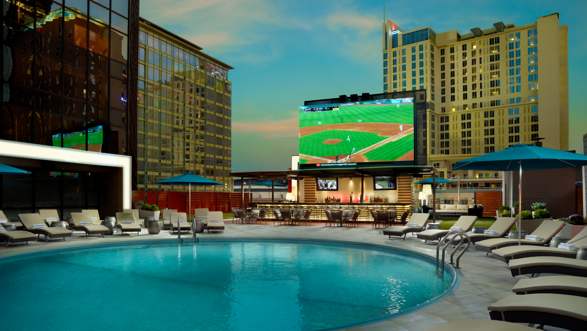 Coon bar rooftop with its swimming pool and led tv showing a baseball match