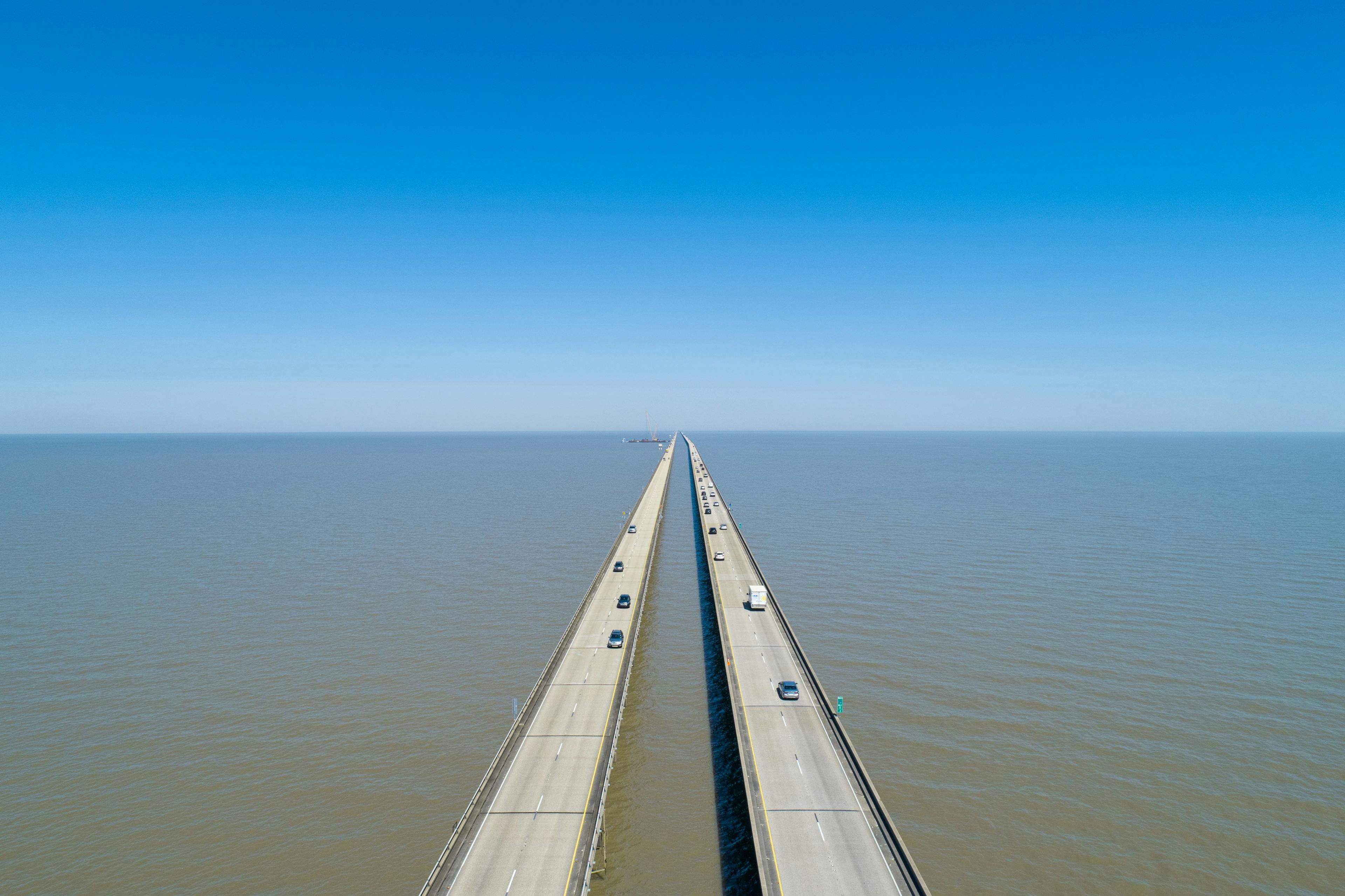 Lake Pontchartrain Causeway bridge with some cars passing on it from an above angle