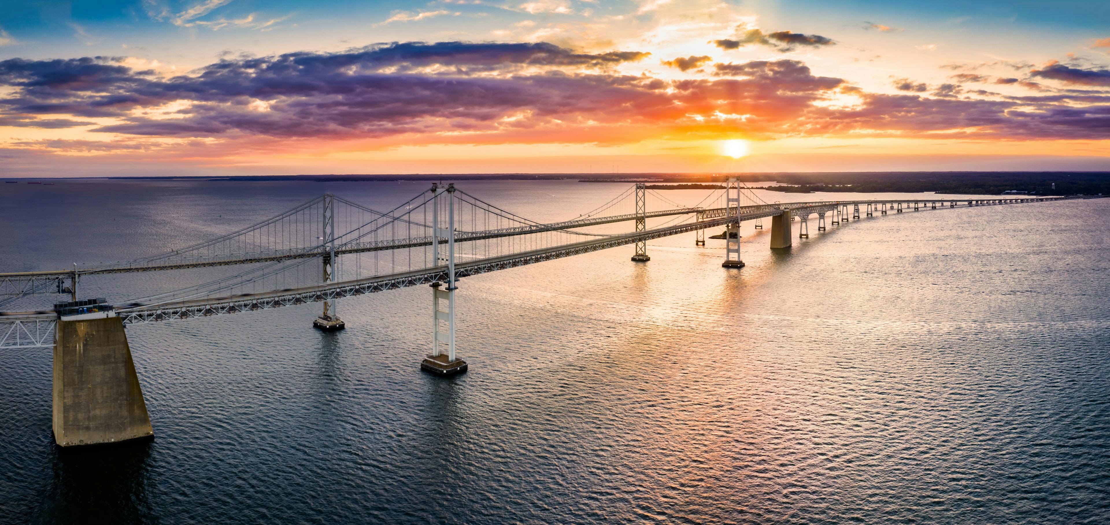 The Chesapeake Bay Bridge from the side, with water at sunset