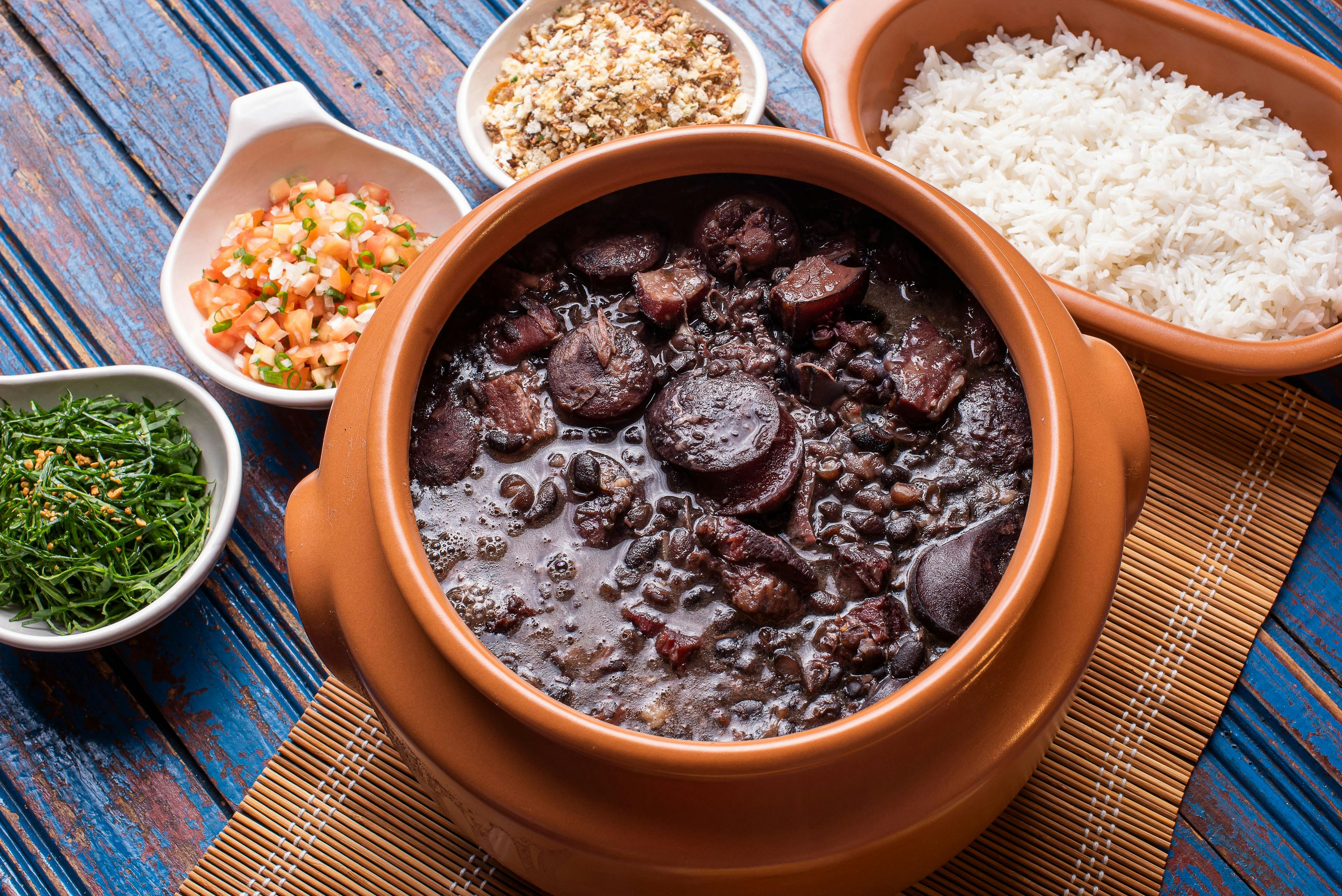 Traditional Brazilian food called feijoada. Black beans with pork