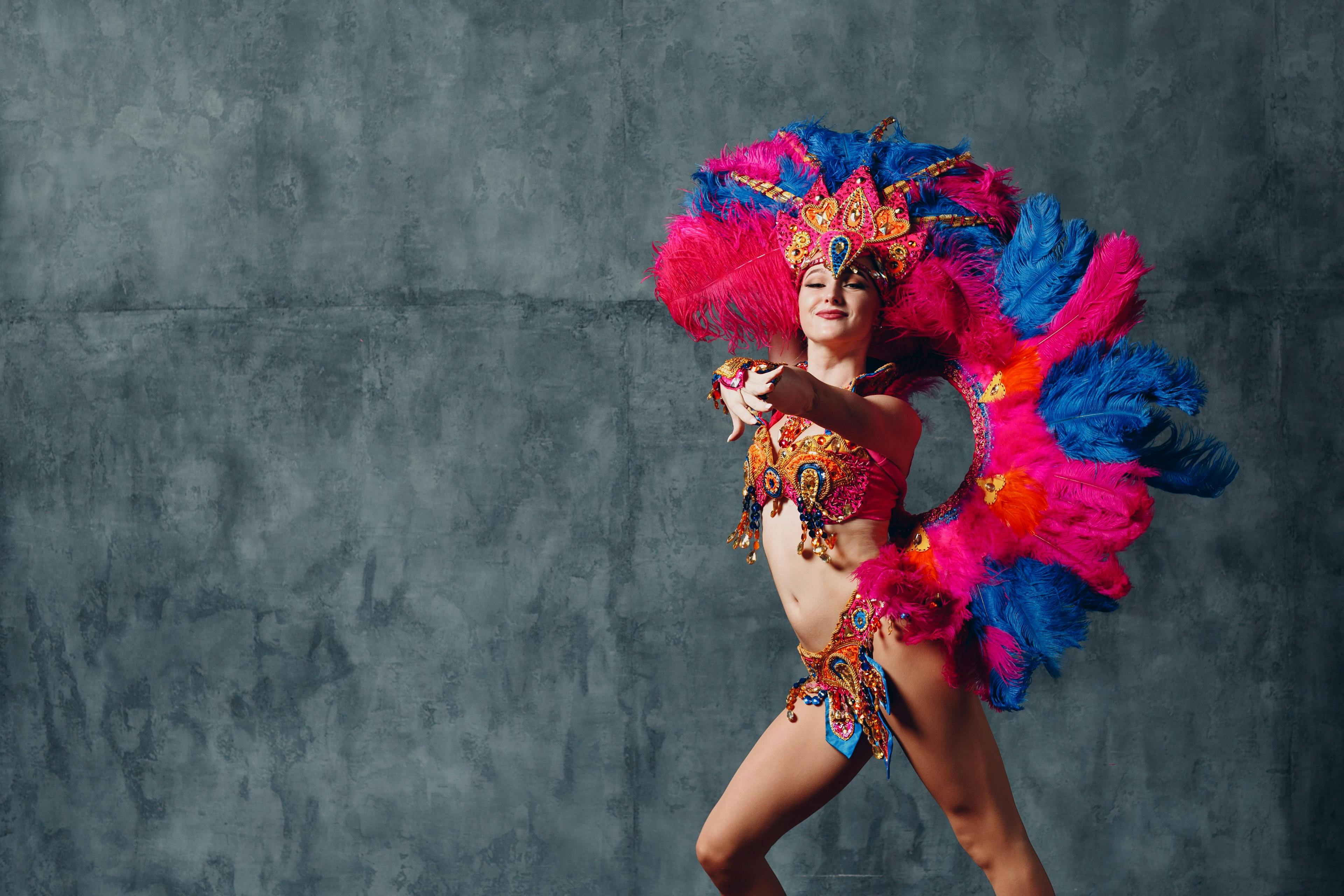 Woman in brazilian samba carnival costume with colorful feathers plumage.